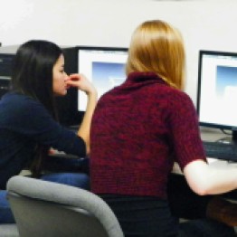 Some of our lady team members work on designing robot parts on CAD.